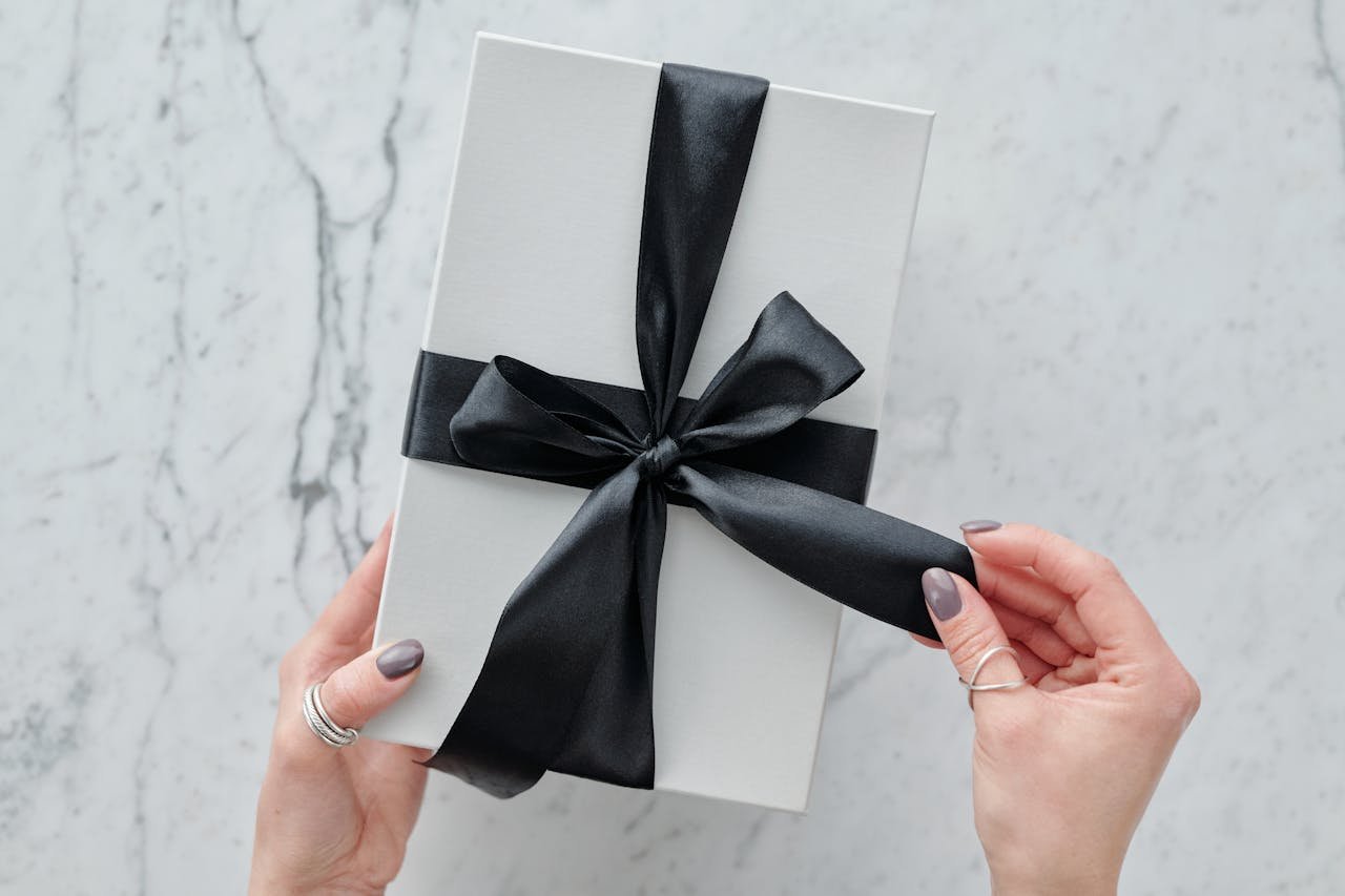 Mastering the First Impression: Your intriguing post title goes here A sleek white present tied with a black satin ribbon, providing a touch of luxury. Ideal for gift themes.
